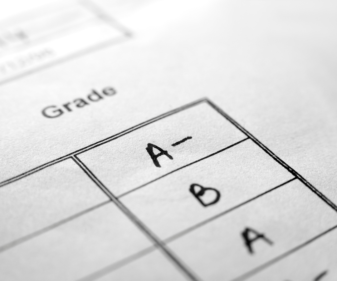 Image of paper marked with letter grades