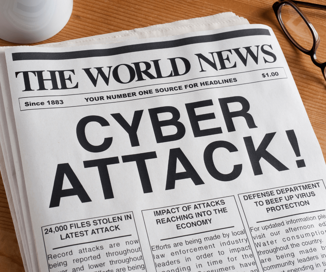 Newspaper with the headline 'Cyber Attack' on a table, illustrating the current state of cybersecurity affairs.